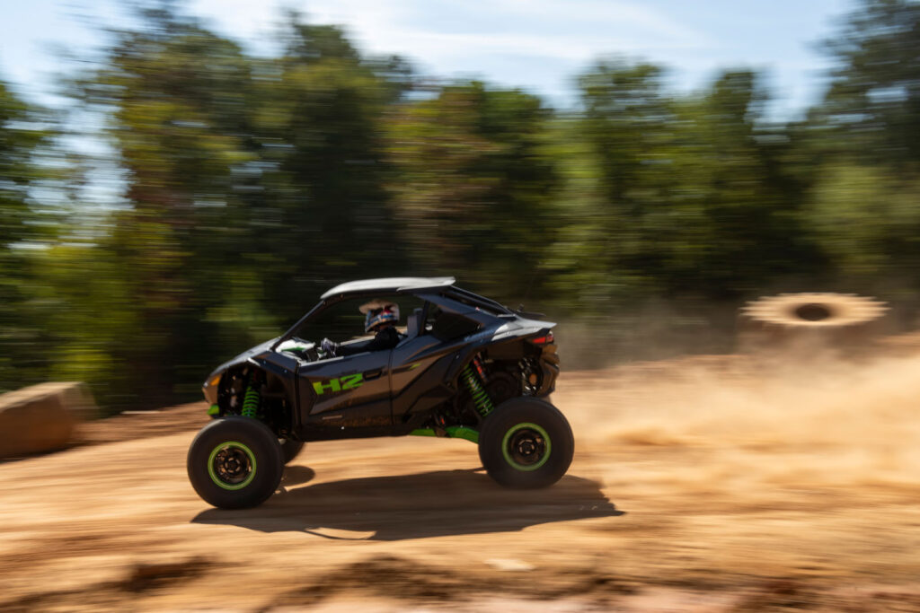 Side profile of the 2027 Kawasaki TERYX H2 LIMITED eS traveling at speed during testing.