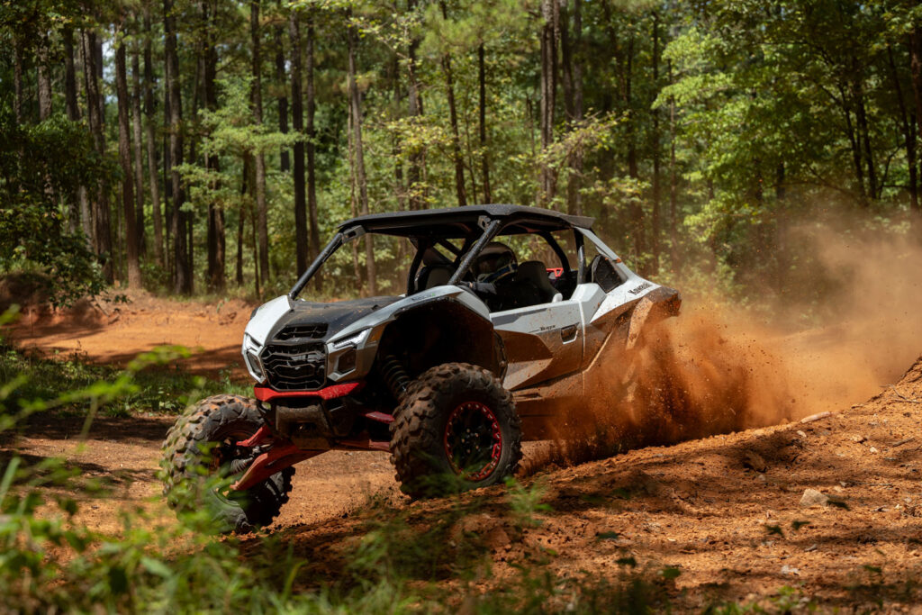 2027 Kawasaki TERYX H2 LIMITED eS powering out of ruts on a wooded trail during testing.2027 Kawasaki TERYX H2 LIMITED eS powering out of ruts on a wooded trail during testing.