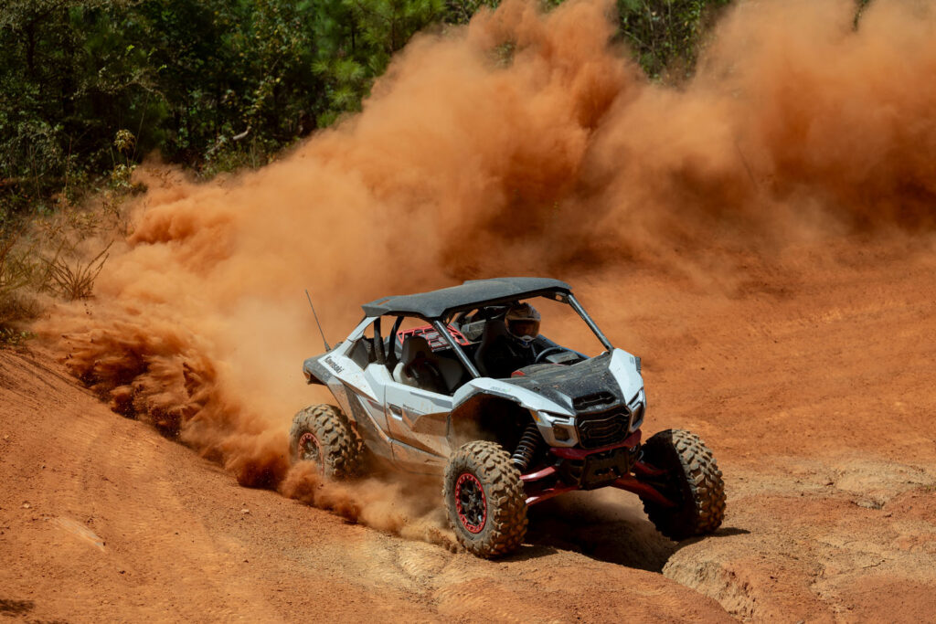 2027 Kawasaki TERYX H2 LIMITED eS powering through a sweeping turn and throwing a large roost during testing.