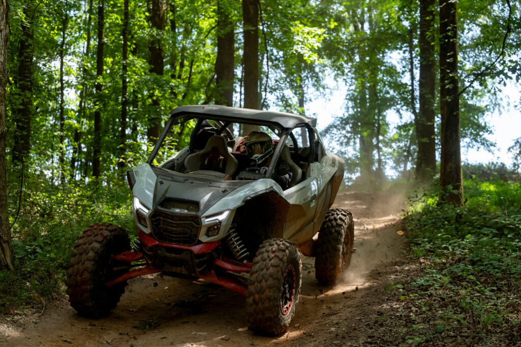 2027 Kawasaki TERYX H2 LIMITED eS braking on a mild downhill trail descent during